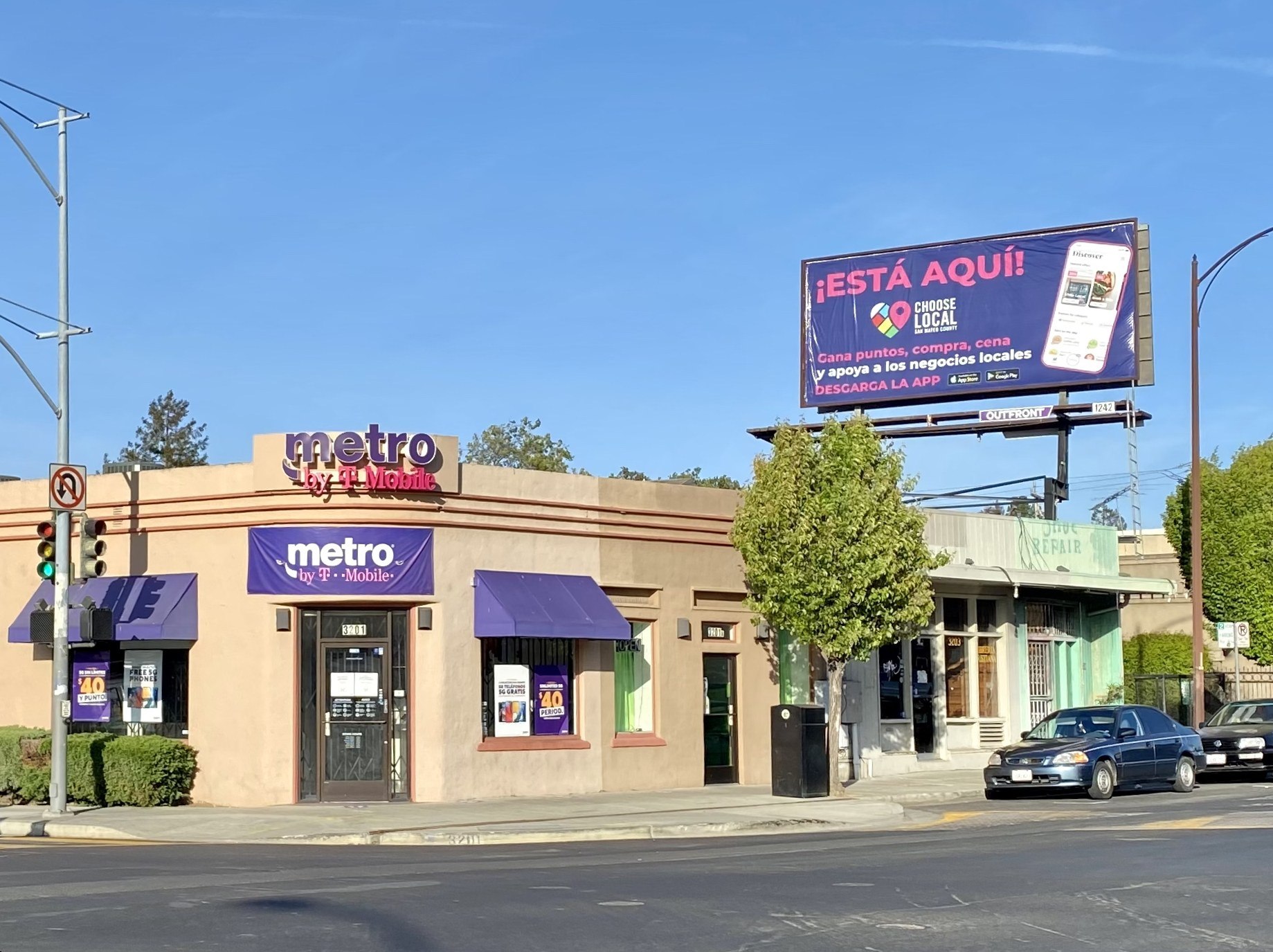 Metro by T-Mobile in Redwood City, CA. A billboard in Spanish and a party car with Spanish graffiti can be seen. (Metro by T-Mobile)